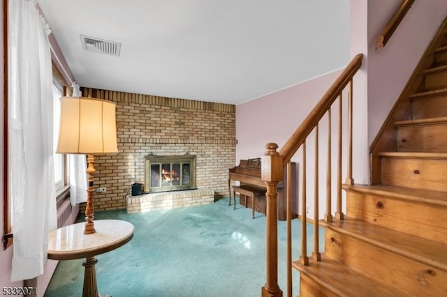 carpeted living room with a fireplace