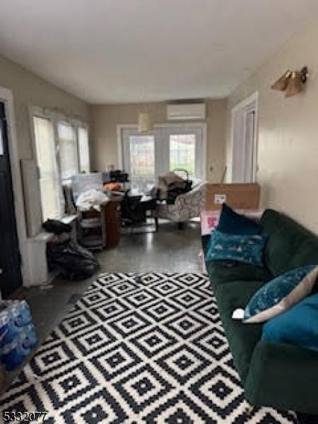 living room with a wall unit AC and wood-type flooring