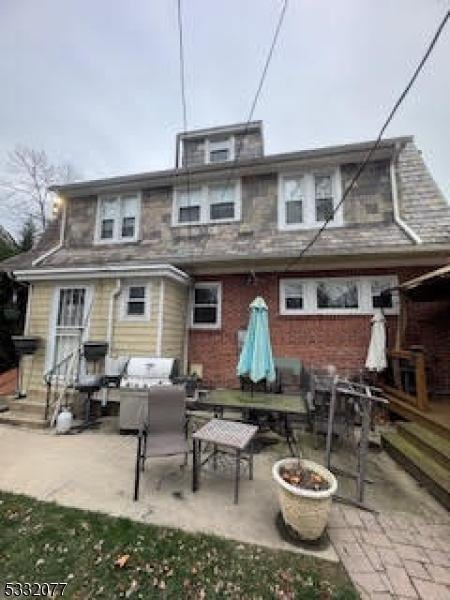 rear view of property featuring a patio and an outdoor hangout area