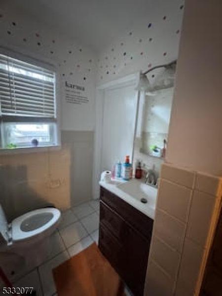 bathroom featuring tile patterned flooring, vanity, and toilet