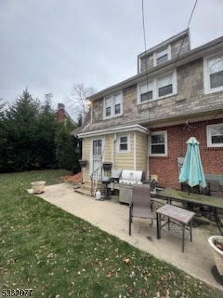 back of property with an outdoor hangout area, a patio area, and a lawn