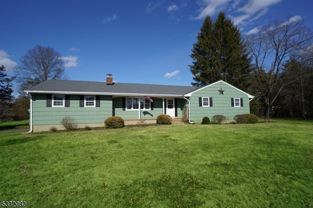 single story home featuring a chimney and a front yard