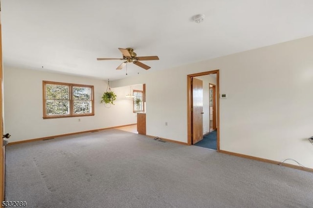 unfurnished room featuring carpet, baseboards, and a ceiling fan