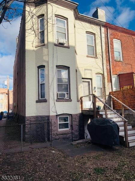 rear view of house with cooling unit