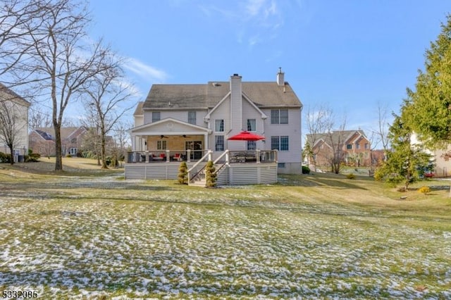 rear view of house featuring a porch, a yard, and ceiling fan