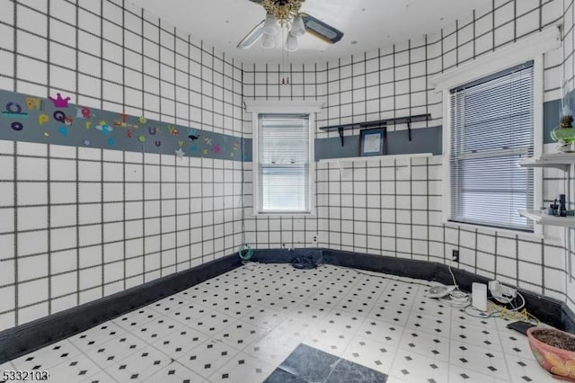 bathroom featuring tile walls and ceiling fan