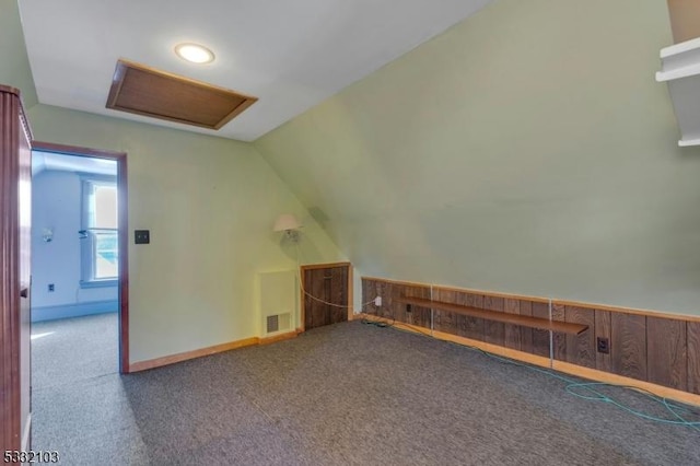 bonus room with carpet floors and vaulted ceiling