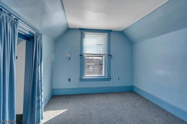 bonus room with carpet flooring and lofted ceiling