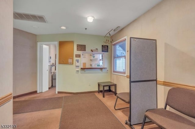 kitchen with stainless steel fridge and light colored carpet