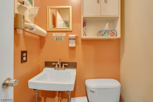 bathroom featuring sink and toilet