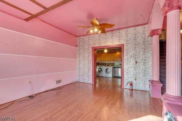 unfurnished living room with decorative columns, ceiling fan, washer and clothes dryer, and hardwood / wood-style flooring