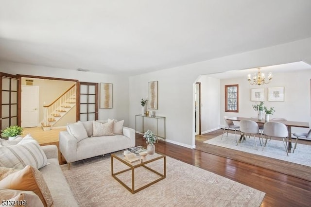 living room featuring a chandelier and hardwood / wood-style floors