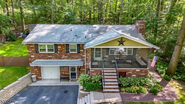 view of front of property featuring a porch and a garage