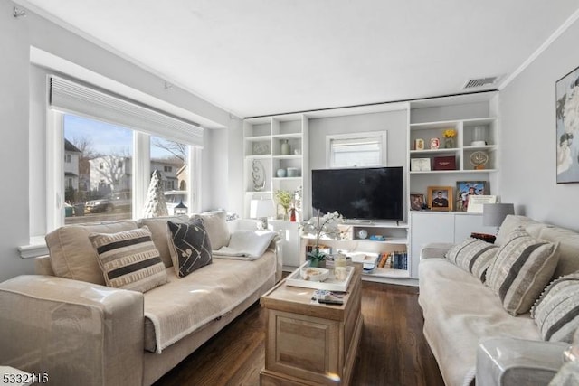 living room featuring dark wood-type flooring and ornamental molding