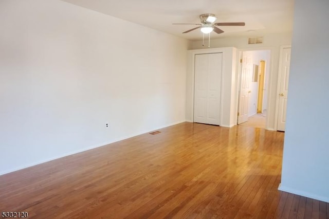 empty room featuring ceiling fan and hardwood / wood-style floors