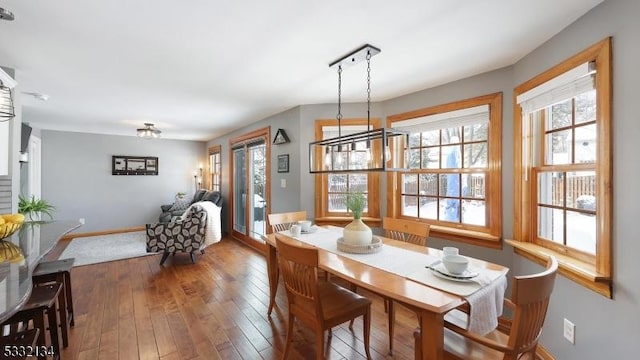 dining space with dark wood-type flooring