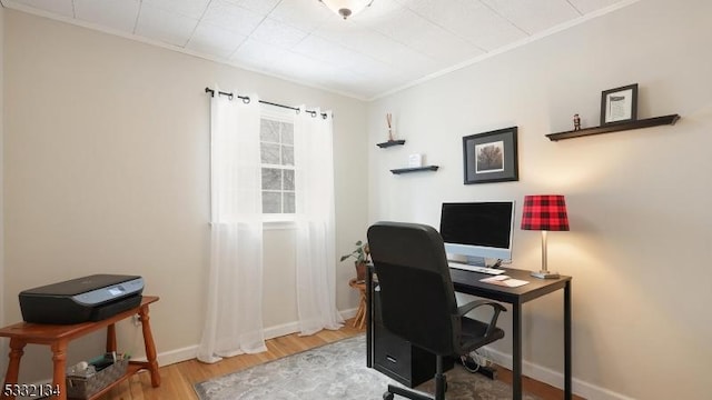 home office with ornamental molding and hardwood / wood-style floors