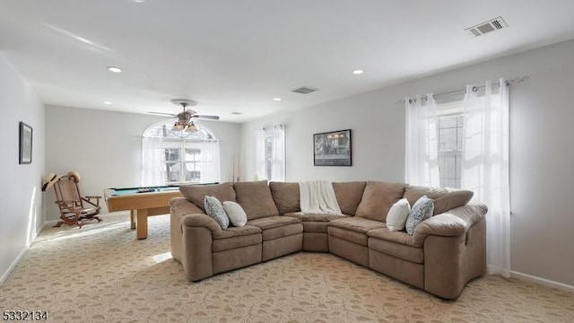 carpeted living room featuring ceiling fan and pool table