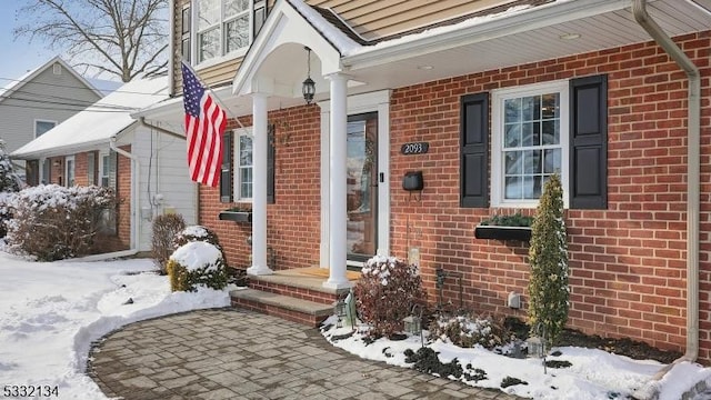 view of snow covered property entrance