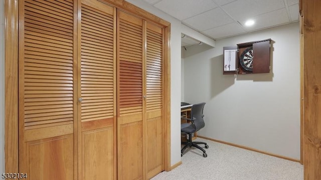 carpeted office with a drop ceiling