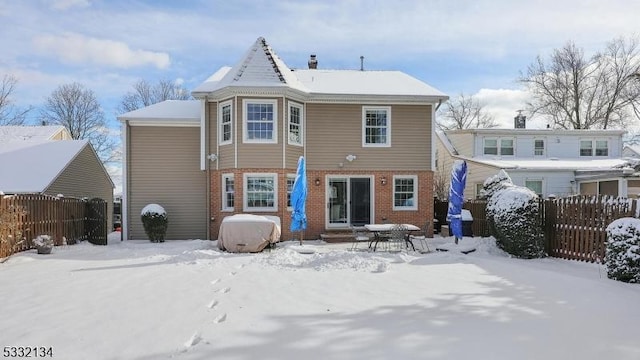 view of snow covered rear of property