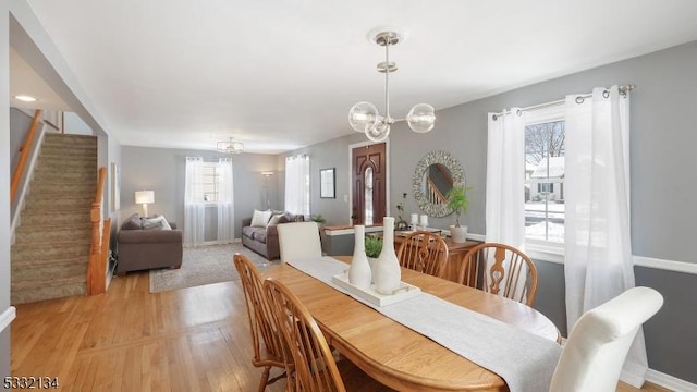 dining space featuring a chandelier and light hardwood / wood-style flooring