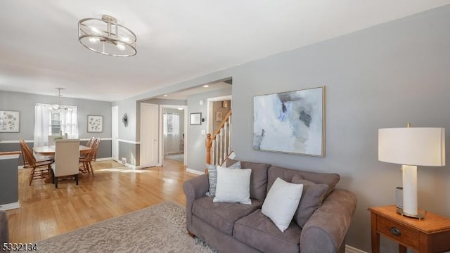 living room with a chandelier and light hardwood / wood-style flooring