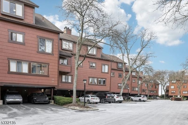 view of building exterior featuring uncovered parking