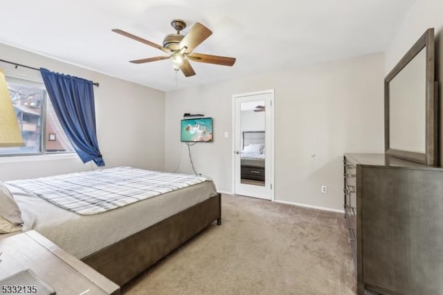 carpeted bedroom with baseboards and a ceiling fan