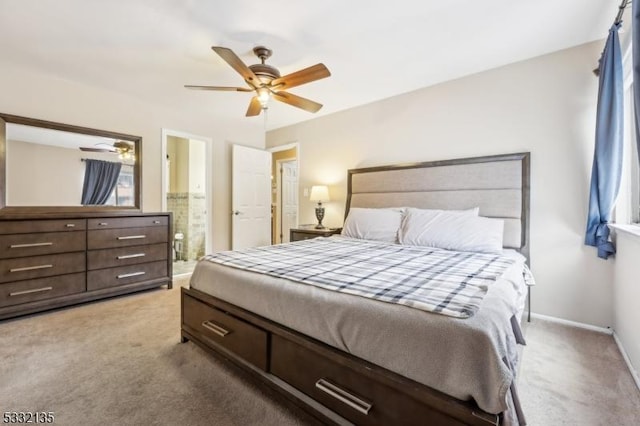 carpeted bedroom featuring a ceiling fan, connected bathroom, and baseboards