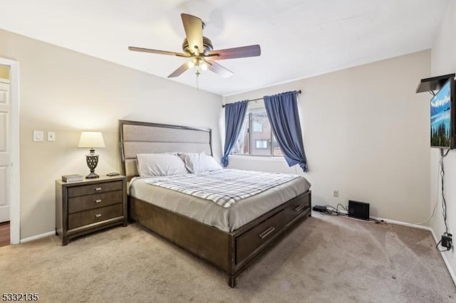 bedroom with ceiling fan, baseboards, and light colored carpet