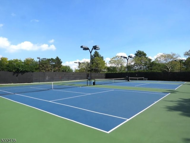 view of sport court featuring fence