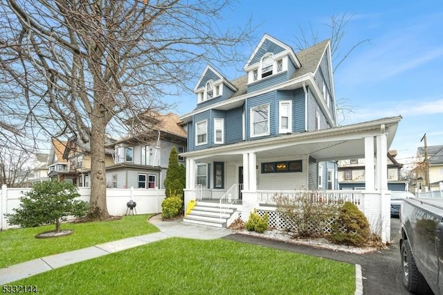 victorian-style house with a front yard and a porch