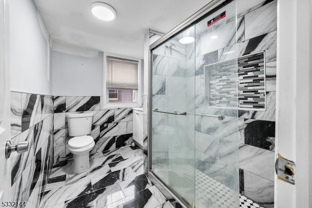 bathroom featuring an enclosed shower, tile walls, and toilet