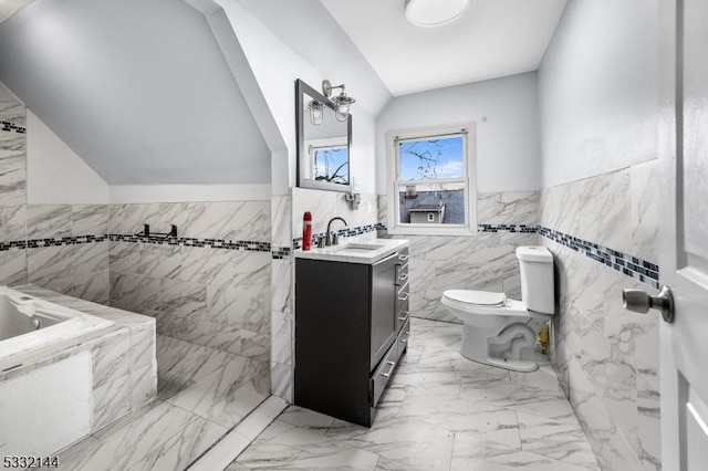 bathroom with vanity, toilet, lofted ceiling, and tile walls