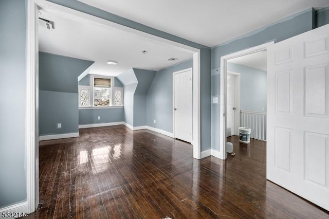 bonus room with vaulted ceiling and dark hardwood / wood-style floors