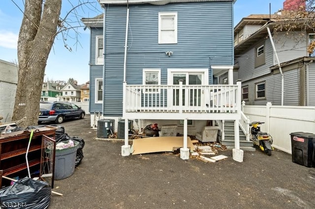 back of house with central AC and a wooden deck