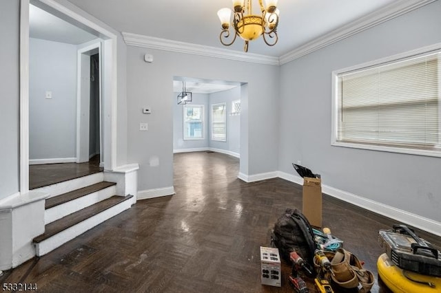 unfurnished dining area with ornamental molding, a chandelier, and dark parquet flooring