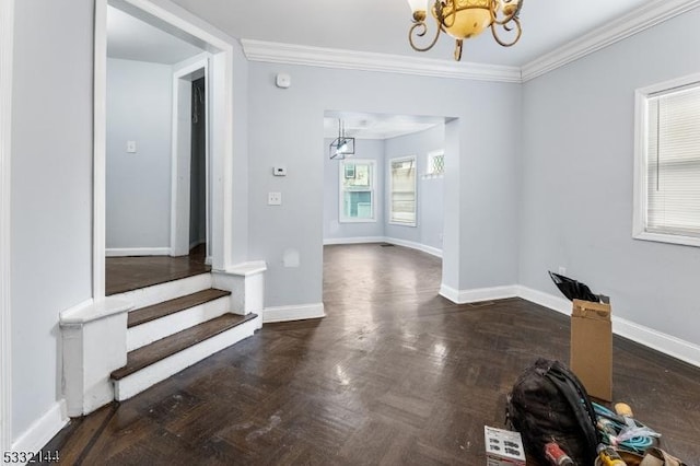 interior space featuring dark parquet flooring, ornamental molding, and a notable chandelier