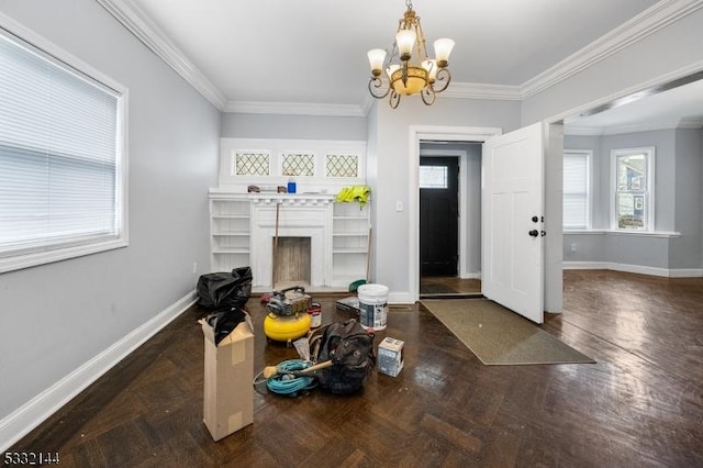 interior space with a chandelier, dark parquet flooring, and ornamental molding