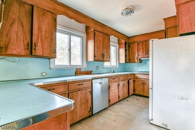 kitchen with white refrigerator and stainless steel dishwasher