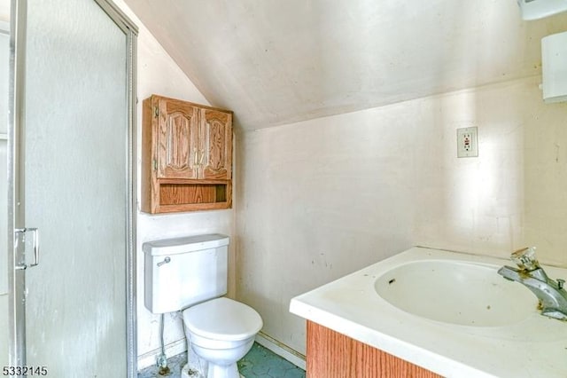 bathroom featuring vanity, toilet, and lofted ceiling