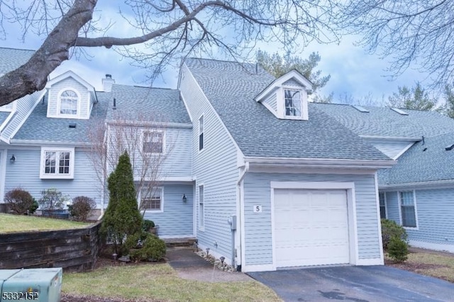 cape cod-style house featuring a garage