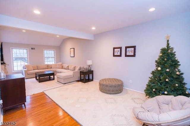 living room with vaulted ceiling with beams and wood-type flooring