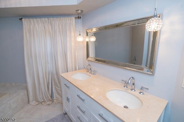 bathroom featuring tile patterned floors, a tub to relax in, and vanity