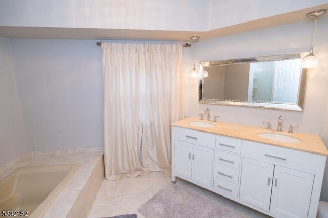 bathroom featuring tile patterned flooring, a relaxing tiled tub, and vanity