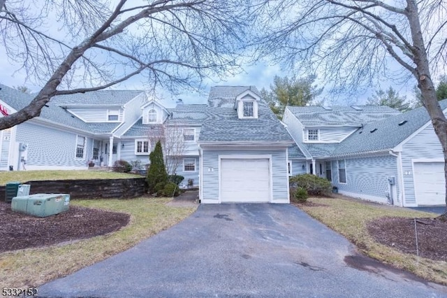 view of front of home with a front yard and a garage