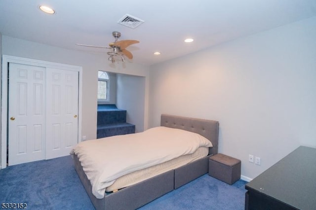 carpeted bedroom featuring ceiling fan and a closet