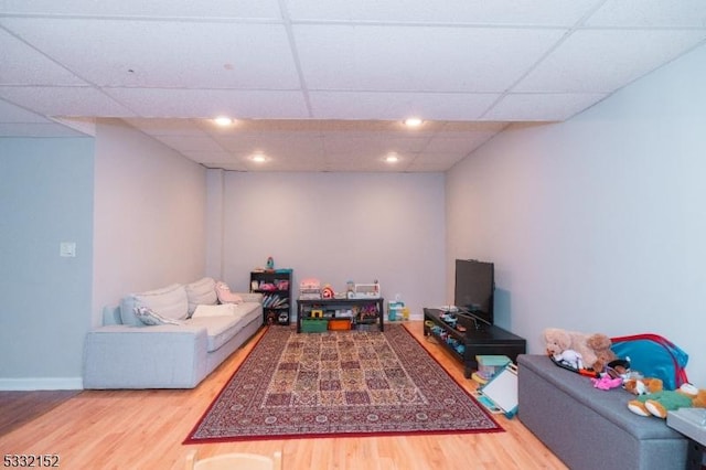 game room featuring wood-type flooring and a drop ceiling