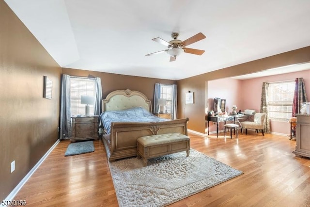 bedroom featuring multiple windows, light hardwood / wood-style flooring, and ceiling fan